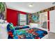 Themed bedroom with custom wall decor and adjacent bathroom at 3082 Mahalo Dr, Davenport, FL 33897