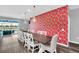 Elegant dining room with a long table, designer lighting, and a view of the outdoor space at 3082 Mahalo Dr, Davenport, FL 33897