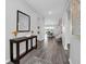 Spacious entryway featuring wood floors, a console table with decorative items, and an open view of the dining area at 3082 Mahalo Dr, Davenport, FL 33897
