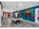 Game room with a billiard table under pendant lights, and custom colorful graffiti-style wall art at 3082 Mahalo Dr, Davenport, FL 33897