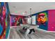 Entertaining game room featuring a billiard table, gray wood-look flooring, and unique graffiti-style wall art at 3082 Mahalo Dr, Davenport, FL 33897