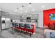 Stylish kitchen featuring stainless steel appliances, a center island with seating, and a view into the living area at 3082 Mahalo Dr, Davenport, FL 33897