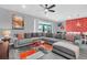 Inviting living room featuring a large sectional sofa, stylish rug, and unique wall art at 3082 Mahalo Dr, Davenport, FL 33897