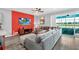 Comfortable living room with a plush sectional sofa, TV, stylish decor, and sliding glass doors leading to the outdoor area at 3082 Mahalo Dr, Davenport, FL 33897