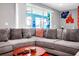Comfortable living room with a plush sectional sofa, neutral tones, and a view of the pool area at 3082 Mahalo Dr, Davenport, FL 33897