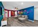 Fun living room featuring unique colorful artwork and a comfortable sectional sofa at 3082 Mahalo Dr, Davenport, FL 33897