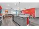 Open concept living space with a kitchen island, dining area, and living room featuring stylish decor and a view of the pool at 3082 Mahalo Dr, Davenport, FL 33897