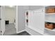 Well-organized mudroom with built-in storage, coat hooks, and stylish tile flooring, offering practical functionality at 3082 Mahalo Dr, Davenport, FL 33897