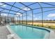 A screened in pool and spa offer a relaxing retreat with expansive views of the community and blue skies at 3082 Mahalo Dr, Davenport, FL 33897