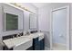 This bathroom features double sinks, framed mirrors, and ample lighting for a bright and functional space at 3150 Rider Pl, Orlando, FL 32817
