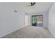 Carpeted bedroom with ceiling fan and sliding glass door view of an outdoor pool and seating area at 3150 Rider Pl, Orlando, FL 32817