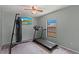 This bedroom features a ceiling fan, window, and exercise equipment including a treadmill and punching bag at 3150 Rider Pl, Orlando, FL 32817