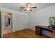 The bedroom has a ceiling fan, large closet, laminate flooring and a view into another room at 3150 Rider Pl, Orlando, FL 32817