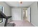 The carpeted bedroom offers a large closet and a window overlooking the exterior at 3150 Rider Pl, Orlando, FL 32817