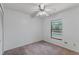 This bedroom features a ceiling fan, large window, carpet and access to a view of the community pool at 3150 Rider Pl, Orlando, FL 32817