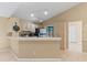 An eat-in kitchen with light wood cabinets, stainless appliances, and access to an outdoor patio at 3150 Rider Pl, Orlando, FL 32817