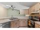 Kitchen with stainless steel appliances, light wood cabinets, and a double sink with modern faucet at 3150 Rider Pl, Orlando, FL 32817