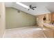 Open-concept living room with tile floors, neutral walls, and vaulted ceiling featuring a skylight and a ceiling fan at 3150 Rider Pl, Orlando, FL 32817