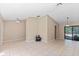 Spacious living area featuring tile flooring, vaulted ceiling, and sliding glass doors leading to the pool area at 3150 Rider Pl, Orlando, FL 32817