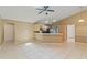 Open-plan living area with tile floors and kitchen featuring a breakfast bar, cabinets, and a view of outdoor patio at 3150 Rider Pl, Orlando, FL 32817