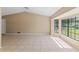 Bright living room with tile flooring, vaulted ceiling, and a large window showcasing a lovely outdoor view at 3150 Rider Pl, Orlando, FL 32817