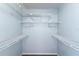 Walk-in closet featuring white wire shelving and pale blue walls, offering ample storage at 3150 Rider Pl, Orlando, FL 32817