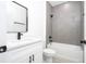 Bathroom featuring a white vanity, gray tiled walk-in shower, and black fixtures at 3211 Sw 128Th Street Rd, Ocala, FL 34473