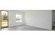 Bedroom featuring white walls, light wood-look floors, and a window with a view of the outdoors at 3211 Sw 128Th Street Rd, Ocala, FL 34473