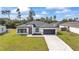 Beautiful home with a well-manicured lawn, gray roof, and a spacious two-car garage at 3211 Sw 128Th Street Rd, Ocala, FL 34473