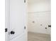 Bright laundry room featuring wood-look flooring and a wire shelf for ample storage at 3211 Sw 128Th Street Rd, Ocala, FL 34473