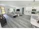 Spacious living room with modern furniture, open to the kitchen, offering a bright and airy space at 3211 Sw 128Th Street Rd, Ocala, FL 34473