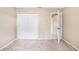 Neutral bedroom with carpet and a closet showing the doorway and tile floor of an adjacent bathroom at 3304 Vancouver Ave, Deltona, FL 32738