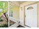 A close up of the house's front door, protected by a screened in porch with tropical foliage at 3304 Vancouver Ave, Deltona, FL 32738