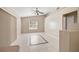 Bright living room featuring tile floors, ceiling fan, and view to the outside at 3304 Vancouver Ave, Deltona, FL 32738
