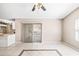 Open concept living room with neutral walls, sliding door and tile flooring at 3304 Vancouver Ave, Deltona, FL 32738