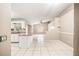 Open concept living room with white tile flooring and view into kitchen at 3304 Vancouver Ave, Deltona, FL 32738
