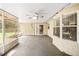 This under-cover patio has a ceiling fan and is partially screened-in with views of the backyard at 3304 Vancouver Ave, Deltona, FL 32738