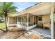 View of the screened porch with patio, palm tree, and exterior of the home at 3304 Vancouver Ave, Deltona, FL 32738