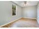 Light and airy bedroom with hardwood floors and natural light from the window at 3431 Hunt Ln, Oviedo, FL 32765