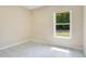 Bedroom with tile flooring, neutral walls, and a large window offering ample natural light at 3431 Hunt Ln, Oviedo, FL 32765