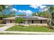 Charming single-story home featuring solar panels and a neatly manicured front lawn at 3431 Hunt Ln, Oviedo, FL 32765