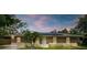 Charming single-story home featuring a cozy front yard and solar panels at 3431 Hunt Ln, Oviedo, FL 32765
