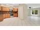 Open kitchen with wood cabinets, stainless steel appliances, and a seamless flow to the living area at 3431 Hunt Ln, Oviedo, FL 32765