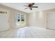 Bright living room featuring white tile flooring and plenty of natural light at 3431 Hunt Ln, Oviedo, FL 32765
