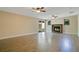 Spacious living room with a cozy fireplace, ceiling fans, and sliding door to the backyard at 3431 Hunt Ln, Oviedo, FL 32765