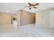 Open concept living area with white floors seamlessly connected to other rooms at 3431 Hunt Ln, Oviedo, FL 32765