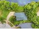 Aerial view of a house with a beautiful roof surrounded by lush greenery and a long driveway at 3501 Danby Ct, Orlando, FL 32812