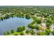 Aerial view showing lakefront properties surrounded by green canopy at 3501 Danby Ct, Orlando, FL 32812