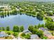 Aerial view of a community lake surrounded by lush greenery and well-maintained homes at 3501 Danby Ct, Orlando, FL 32812