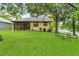 Backyard featuring mature landscaping, green lawn, and outdoor furniture at 3501 Danby Ct, Orlando, FL 32812